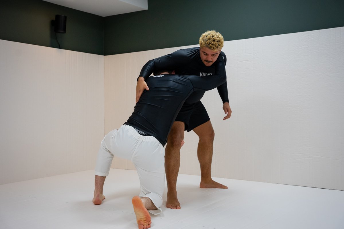 Two students practicing how to deal with situation where one is being taken down.